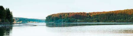 Panoramic autumn photo of amazing and beautiful nature with sky and lakeの写真素材