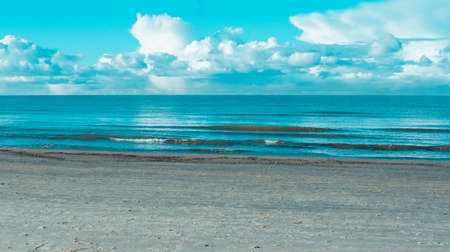 Panoramic landscape sunny photo of beautiful and amazing blue sea and blue sky with clouds.の写真素材