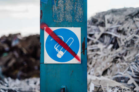Close-up photo of rubbish and garbage in the dump with the sign of no smoking.の写真素材