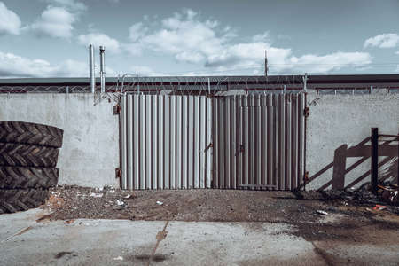 Photo of an iron fence near the factory.の写真素材