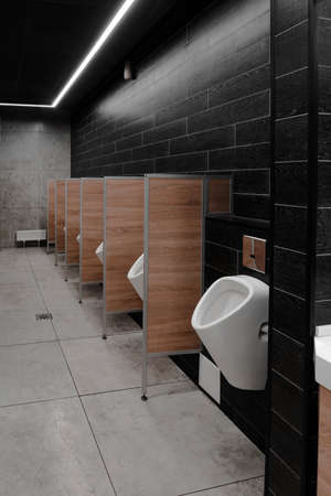 Vertical photo of a men's toilet in a shopping center.の写真素材
