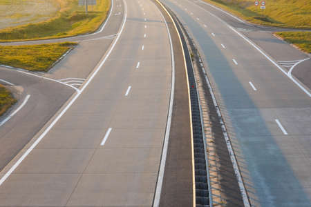 Photo of a gray road with white road markings.の写真素材