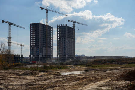 Photo of the construction of a multi-storey buildings and houses.