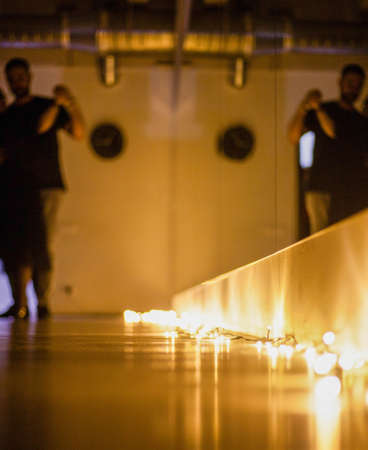 Photo of a dancing couple in a dance hall with mirrors and burning lights on the floor.の写真素材