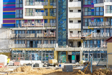 Photo of the construction of a multi-storey buildings and houses.の写真素材
