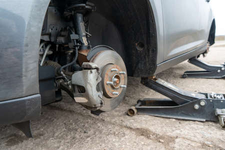 Close-up photograph of a brake disc at a service station. Repair balancing and tire fitting of...