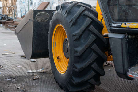 Closeup photograph of a wheel from a large tractor at a manufacturing facility. High quality photo