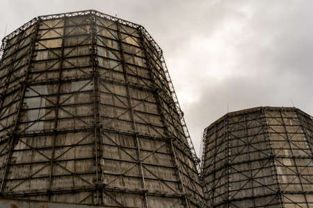 Photo of a thermoelectric plant with big chimneys at the background of sky.の写真素材