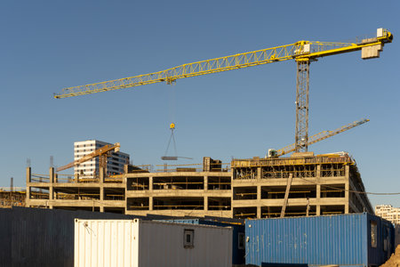 Photo of the construction site and building of high buildings and cranes against blue sky in the city. Constructional concept.の写真素材