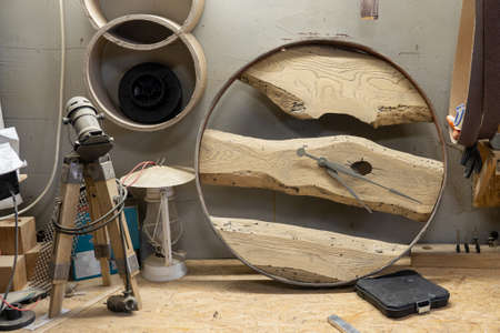 Photo of handmade wooden clocks in the workshop. Wood products.の写真素材