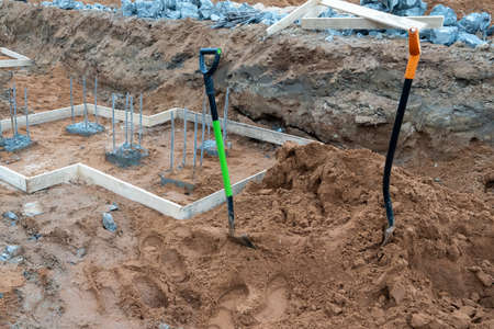 Photo of two shovels sand building foundation.の写真素材