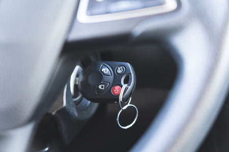 Photo of a car key in the ignition. Cars and transport. Black colors.の写真素材