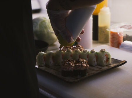 The photo of the finished Japanese food on the plate is beautifully laid out. Chef's hands close upの写真素材