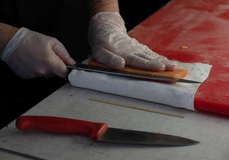 Chef in the kitchen is cutting red fishの写真素材