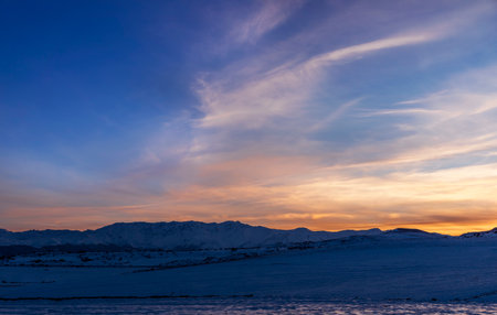 Sunset over the snowy mountains of Iceland. Beautiful winter landscape.の写真素材