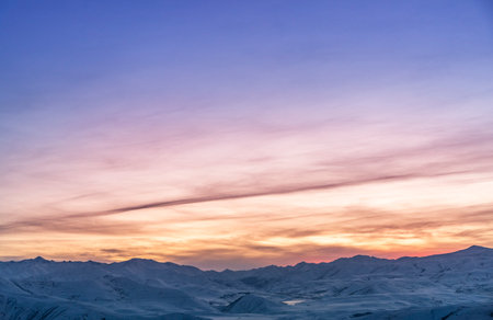 Beautiful sunset over the mountains in winter. View from the ski resort.の写真素材