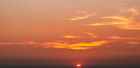 Beautiful sunset in the sky. Sky background. Sky with clouds and sunの写真素材