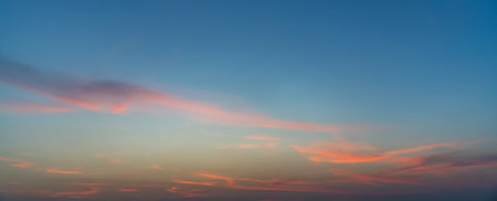 Sunset sky background with tiny clouds. Panoramic image.の写真素材