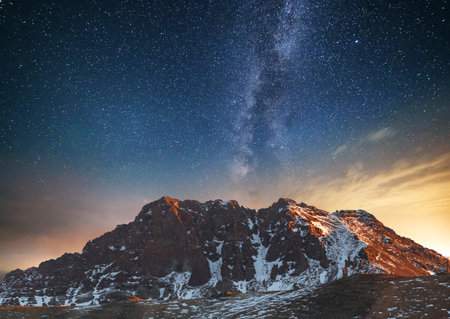 Milky way over the snowy mountains in the Dolomites, Italyの写真素材