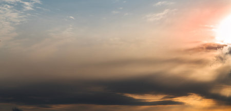 Panorama of sunset sky with clouds and sun rays. Nature background
