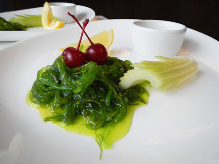 Chuka salad with sesame decorated with cherriesの写真素材