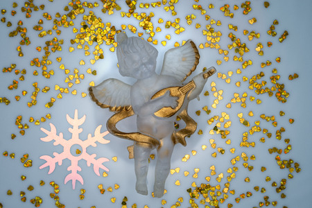 Festive angel playing the guitar surrounded by hearts and snowflakesの写真素材