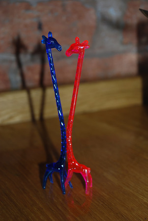 A toy and giraffes on the tableの写真素材