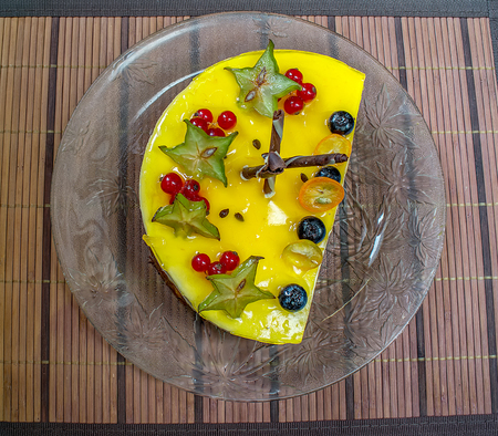yellow jelly cheesecake with berries on plateの写真素材