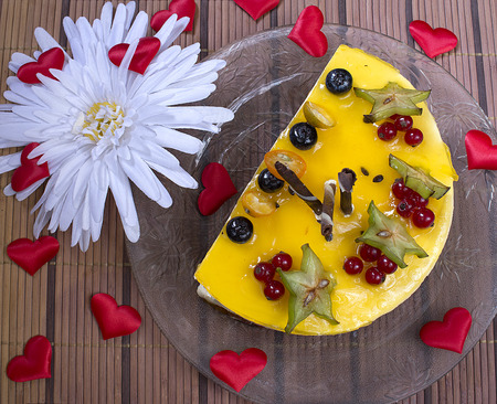 cheesecake with berries red hearts on plateの写真素材
