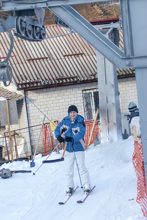young man in jacket with ski and liftの写真素材