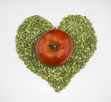 Heart of the green peas and tomatoの写真素材