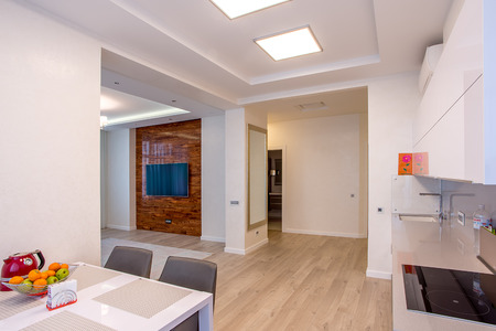 White kitchen with table and large windowsの写真素材