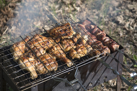 Grilled meat a coals and a logsの写真素材