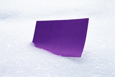 Purple card in snowの写真素材