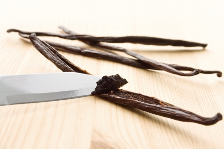 Vanilla mass being scratched out of vanilla beans with a knifeの写真素材