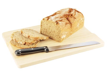 Fresh rye bread with a bread knife on a wooden chopping board isolated on white