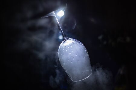 glass on a dark, smoky backgroundの写真素材