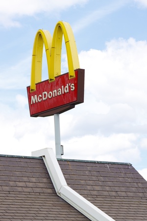 Helmond, The Netherlands - July 7, 2011: McDonald's Corporation is one of the largest chains of fast food restaurants in the world.  The big yellow M with its "golden arches" is one of the most well-known commercial signs and is also a symbol for consumerのeditorial素材