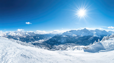Panoramic view of snow-covered mountains with a clear blue sky and bright winter sunshine.の素材
