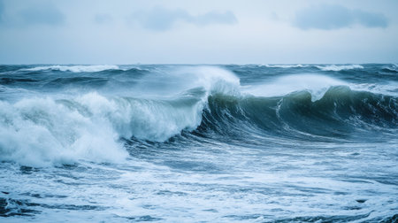 Waves rolling in on a windy day, with whitecaps and gusts of wind stirring up the sea.の素材