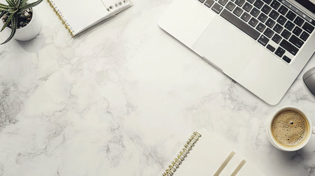 A clean and modern work desk with a laptop, notebook, and coffee cup. The large empty space on the desk surface offers ample room for text.の素材