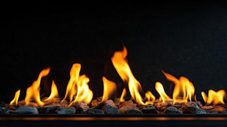 Flames flickering from a fireplace insert with a dark background. The clean space around the fire provides a perfect area for text.の素材