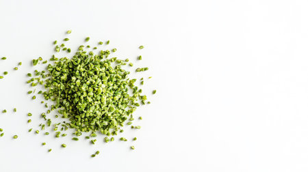 A close-up image showcasing a small pile of fresh green fennel on a clean white background, ideal for culinary use and food styling.の素材
