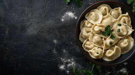 A top view image of traditional pelmeni dumplings in a bowl, garnished with herbs. Perfect for food lovers, culinary enthusiasts, or restaurant menus.の素材