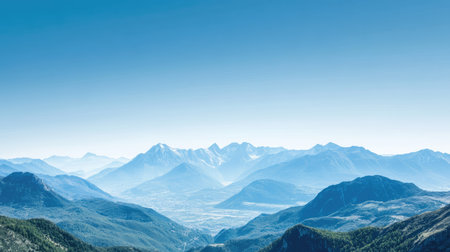Top view of a majestic mountain range with clear blue skies above, leaving ample copy space at the top for text, creating a serene, natural backdrop. -の素材