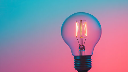 Close-up of a light bulb with a gradient background, leaving the top half of the image clear for text or product details.の素材