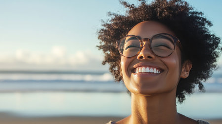 A person with a radiant smile at a beach, with ample space for text in the sky or sand.の素材