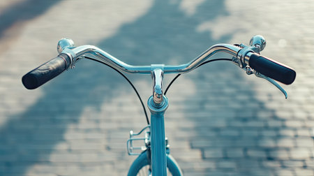Close-up of a bike handlebar at a bike-sharing dock, with copy space on a clean background.の素材