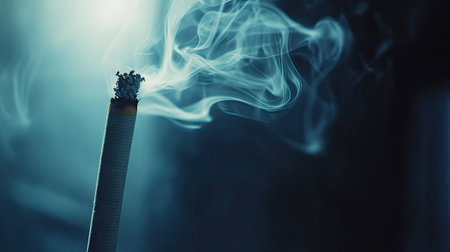 A close-up of cigarette smoke drifting through a dimly lit room, with ample space in the background for text.の素材
