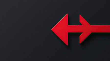 A flat red arrow pointing left with a sharp, geometric design on a black background, standing out in contrast.の素材